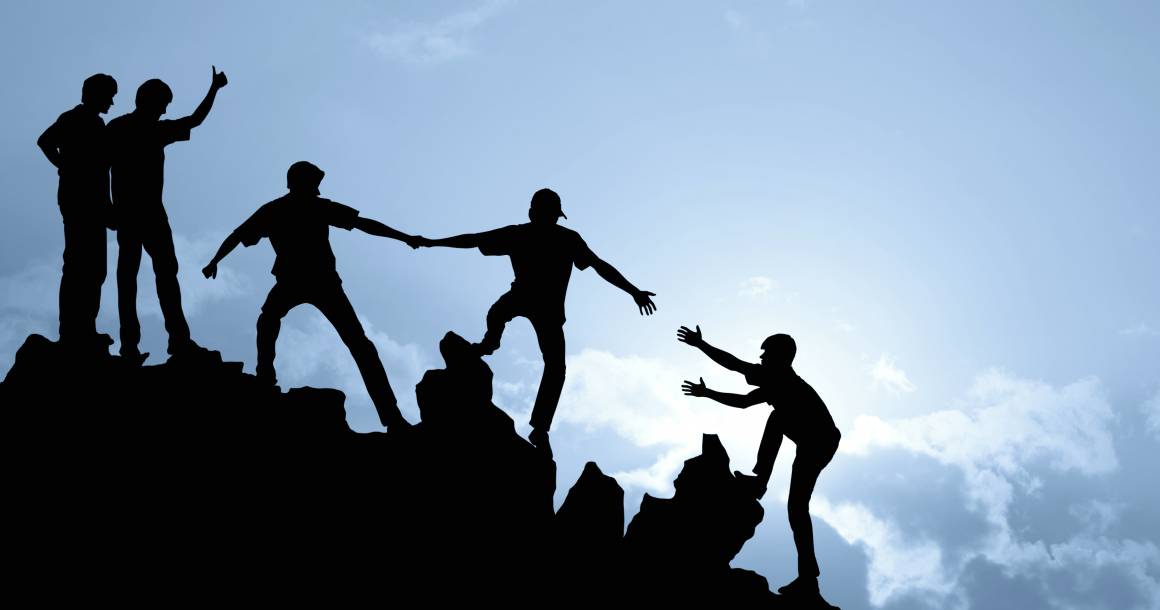 Group of people on peak mountain climbing helping team work , success concept